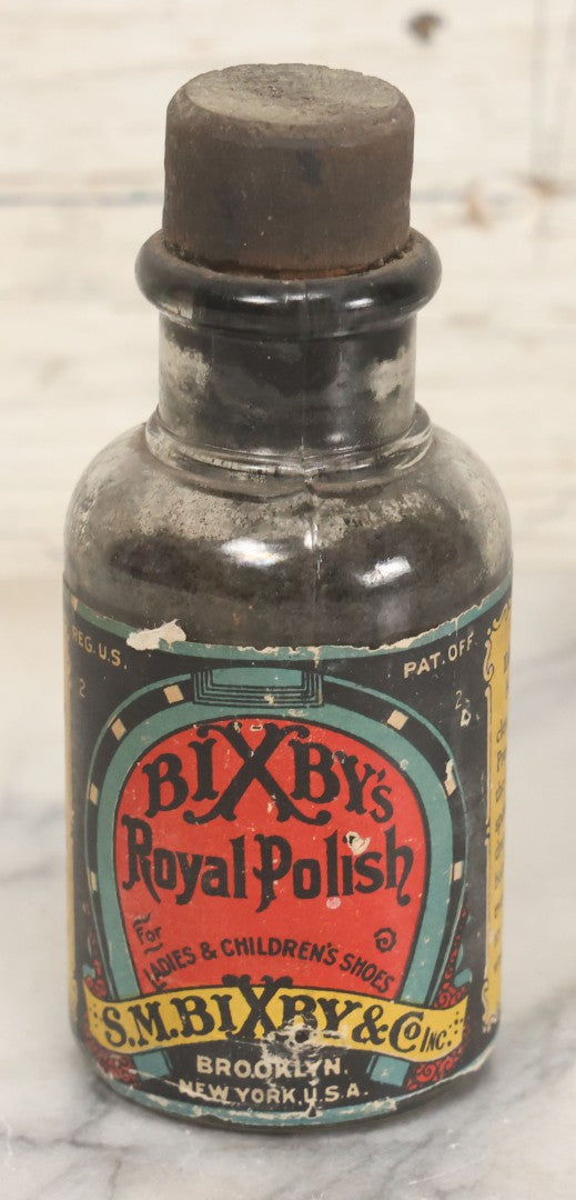 Lot 040 - Grouping Of Four Vintage Ink And Polish Glass Bottles With Paper Labels Including Dyzit Straw Hat Renewer, Sanford's Premium Writing Fluid, Bixby Mahogany Shoe Cleaner, And Bixby Royal Shoe Polish