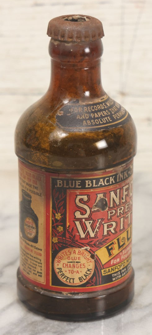 Lot 040 - Grouping Of Four Vintage Ink And Polish Glass Bottles With Paper Labels Including Dyzit Straw Hat Renewer, Sanford's Premium Writing Fluid, Bixby Mahogany Shoe Cleaner, And Bixby Royal Shoe Polish