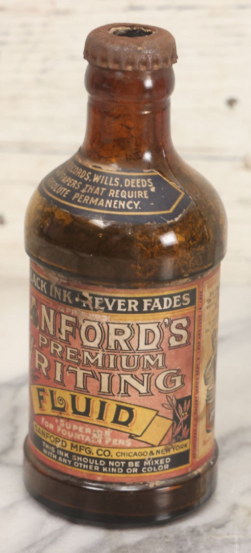 Lot 040 - Grouping Of Four Vintage Ink And Polish Glass Bottles With Paper Labels Including Dyzit Straw Hat Renewer, Sanford's Premium Writing Fluid, Bixby Mahogany Shoe Cleaner, And Bixby Royal Shoe Polish