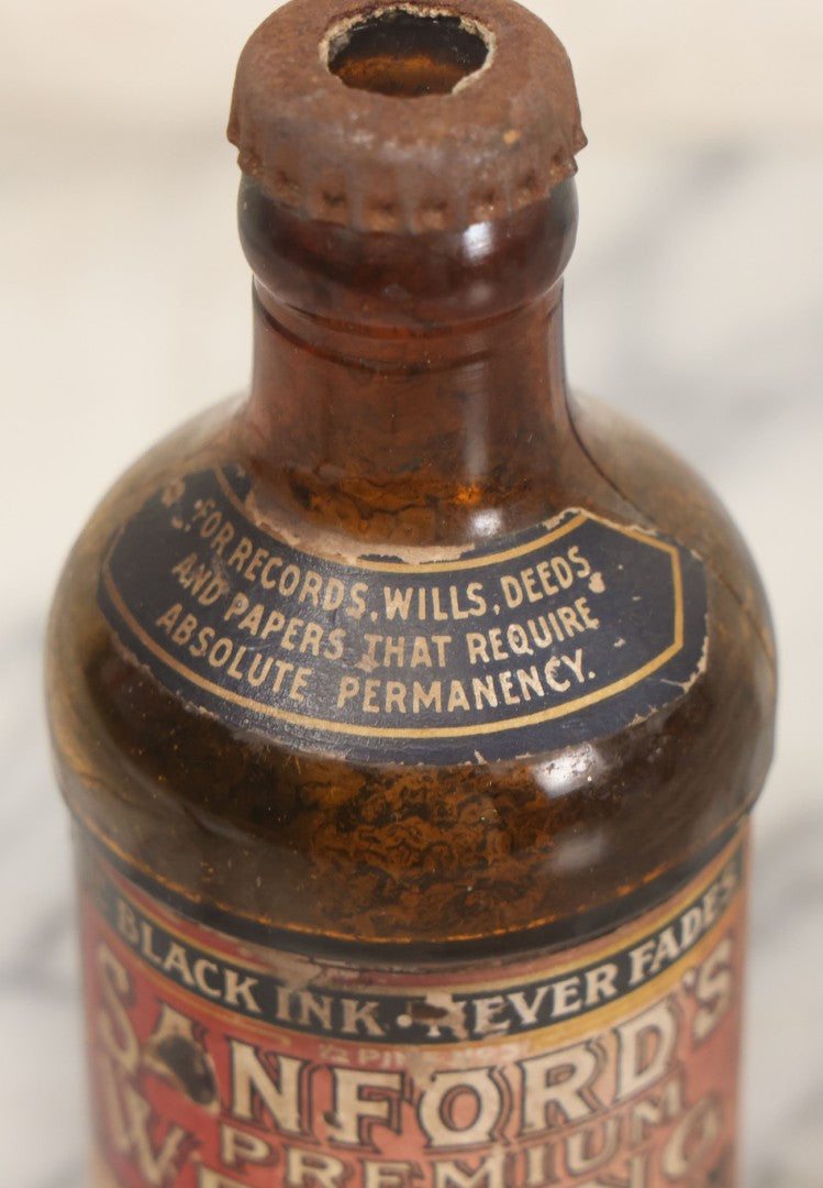 Lot 040 - Grouping Of Four Vintage Ink And Polish Glass Bottles With Paper Labels Including Dyzit Straw Hat Renewer, Sanford's Premium Writing Fluid, Bixby Mahogany Shoe Cleaner, And Bixby Royal Shoe Polish