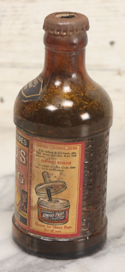 Lot 040 - Grouping Of Four Vintage Ink And Polish Glass Bottles With Paper Labels Including Dyzit Straw Hat Renewer, Sanford's Premium Writing Fluid, Bixby Mahogany Shoe Cleaner, And Bixby Royal Shoe Polish