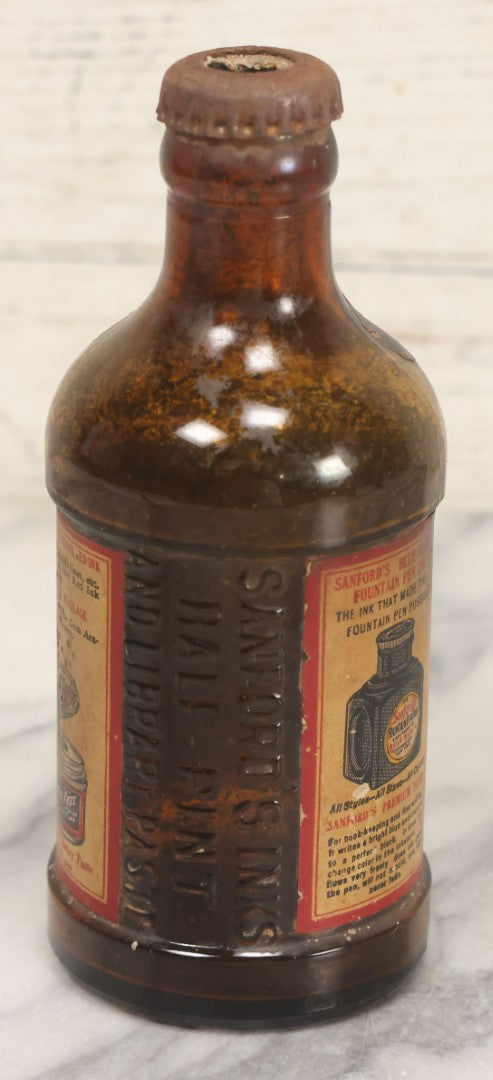 Lot 040 - Grouping Of Four Vintage Ink And Polish Glass Bottles With Paper Labels Including Dyzit Straw Hat Renewer, Sanford's Premium Writing Fluid, Bixby Mahogany Shoe Cleaner, And Bixby Royal Shoe Polish