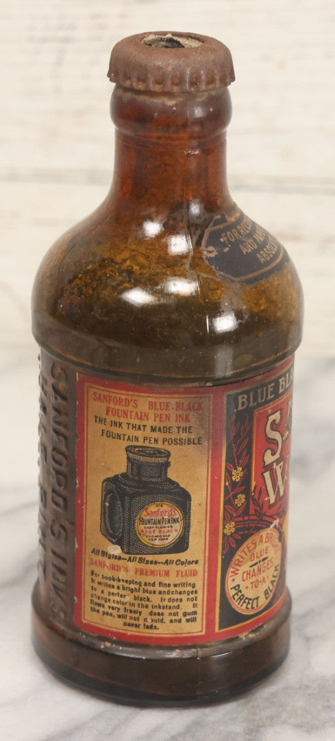 Lot 040 - Grouping Of Four Vintage Ink And Polish Glass Bottles With Paper Labels Including Dyzit Straw Hat Renewer, Sanford's Premium Writing Fluid, Bixby Mahogany Shoe Cleaner, And Bixby Royal Shoe Polish