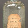 Lot 042 - Antique Superior Hair Oil Clear Glass Bottle With Cork And Remnants Of Contents, Paper Label, Manufactured And Sold By L.F. Wood, West Townsend, Massachusetts, 5-1/4" Height