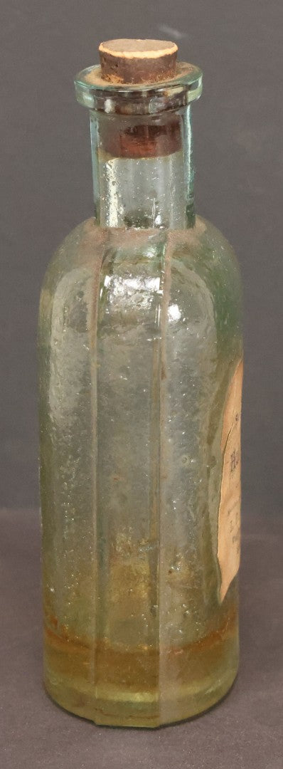 Lot 042 - Antique Superior Hair Oil Clear Glass Bottle With Cork And Remnants Of Contents, Paper Label, Manufactured And Sold By L.F. Wood, West Townsend, Massachusetts, 5-1/4" Height
