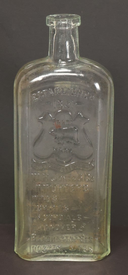 Lot 046 - Antique W.H. Jones & Co. Clear Glass Bottle With Bear Motif Trade Mark, Importers Of Wines, Spirits, And Cordials, Boston, Massachusetts, 8-3/8" Height