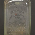 Lot 046 - Antique W.H. Jones & Co. Clear Glass Bottle With Bear Motif Trade Mark, Importers Of Wines, Spirits, And Cordials, Boston, Massachusetts, 8-3/8" Height