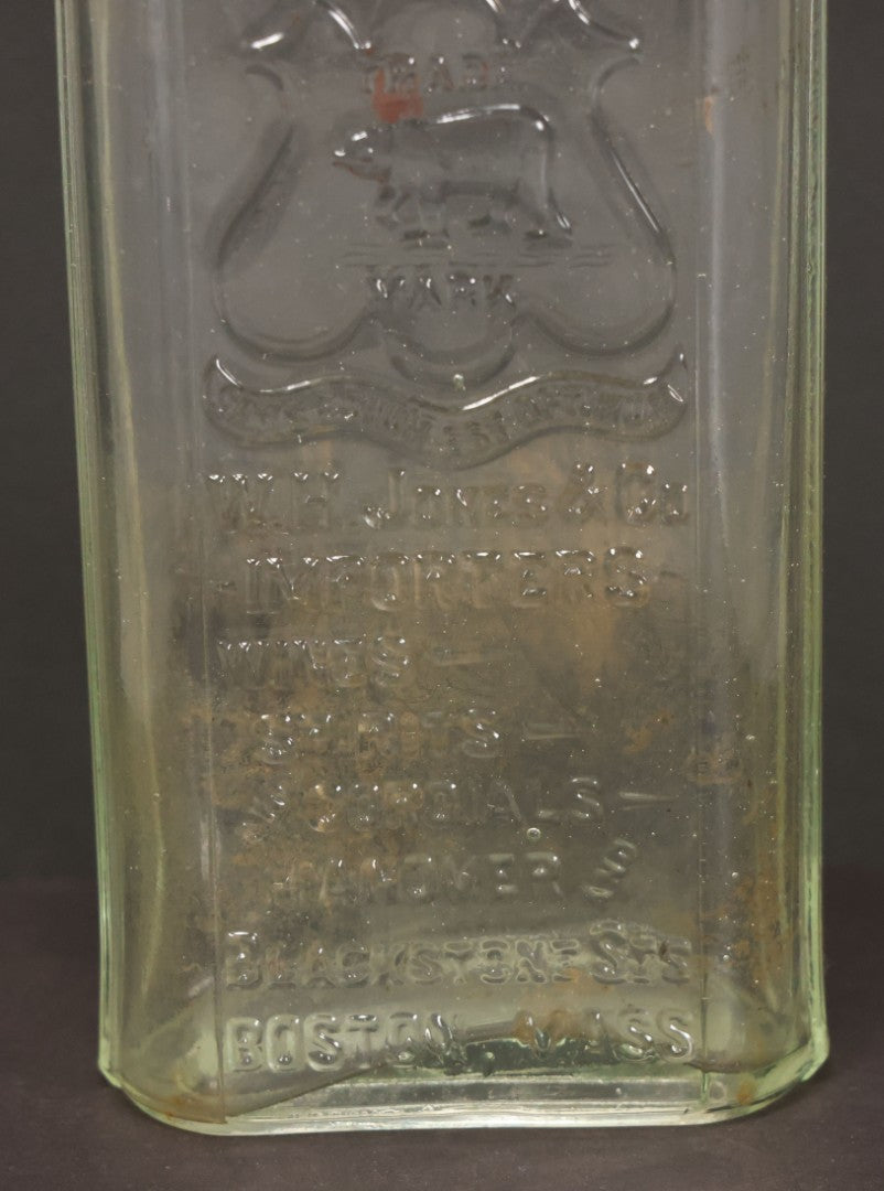 Lot 046 - Antique W.H. Jones & Co. Clear Glass Bottle With Bear Motif Trade Mark, Importers Of Wines, Spirits, And Cordials, Boston, Massachusetts, 8-3/8" Height