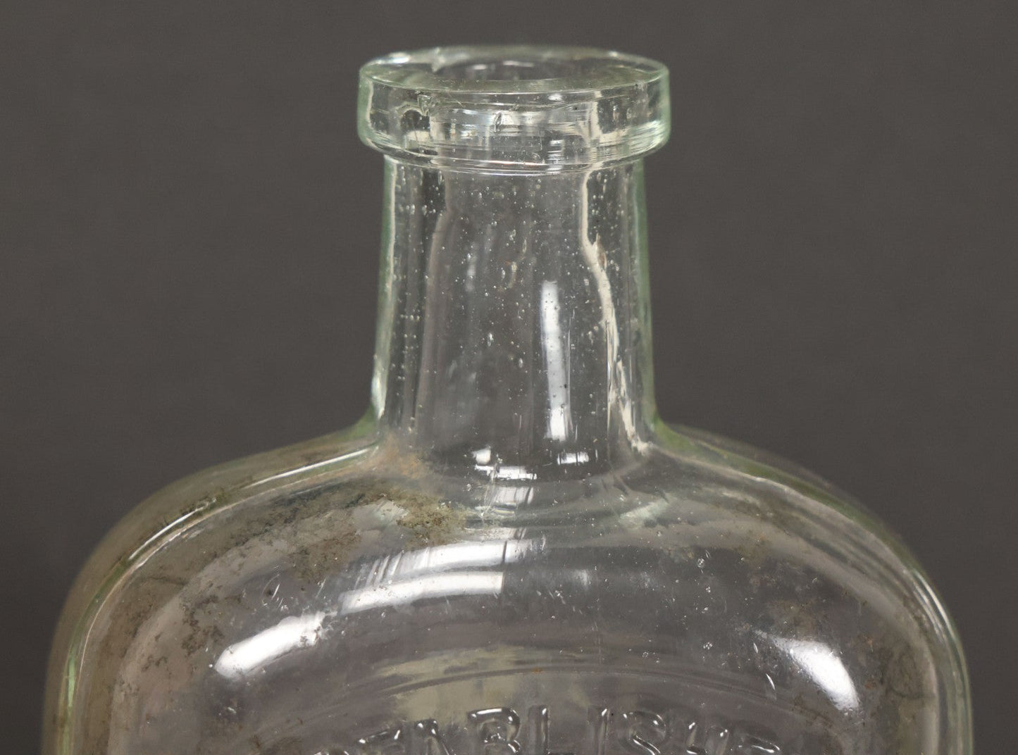 Lot 046 - Antique W.H. Jones & Co. Clear Glass Bottle With Bear Motif Trade Mark, Importers Of Wines, Spirits, And Cordials, Boston, Massachusetts, 8-3/8" Height
