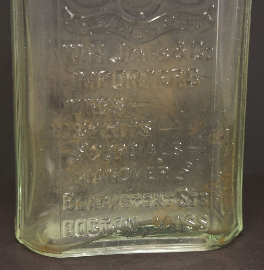 Lot 046 - Antique W.H. Jones & Co. Clear Glass Bottle With Bear Motif Trade Mark, Importers Of Wines, Spirits, And Cordials, Boston, Massachusetts, 8-3/8" Height