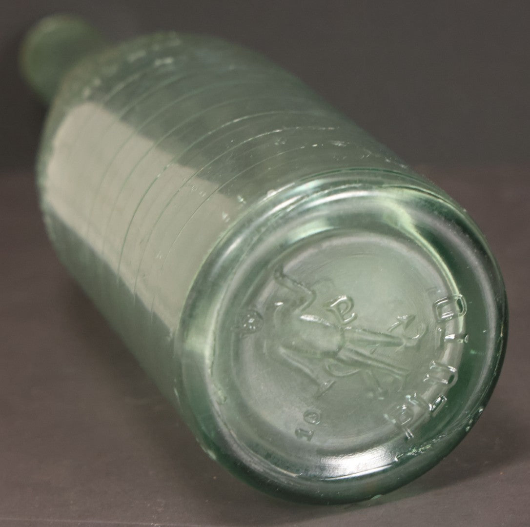Lot 048 - Antique Pluto Water Green Tinted Clear Glass Bottle With Underside Embossed Devil Motif Logo, "America's Physic", 11" Height