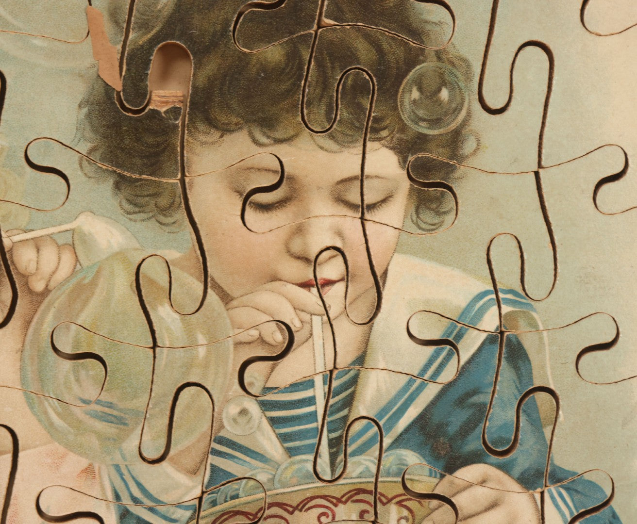 Lot 062 - Antique Double Sided Victorian Lithographed Wood Cut Jigsaw Puzzle With Scene Of Children In Costume With Clown And Children Blowing Bubbles, With Original Box And Partial Lithographed Lid