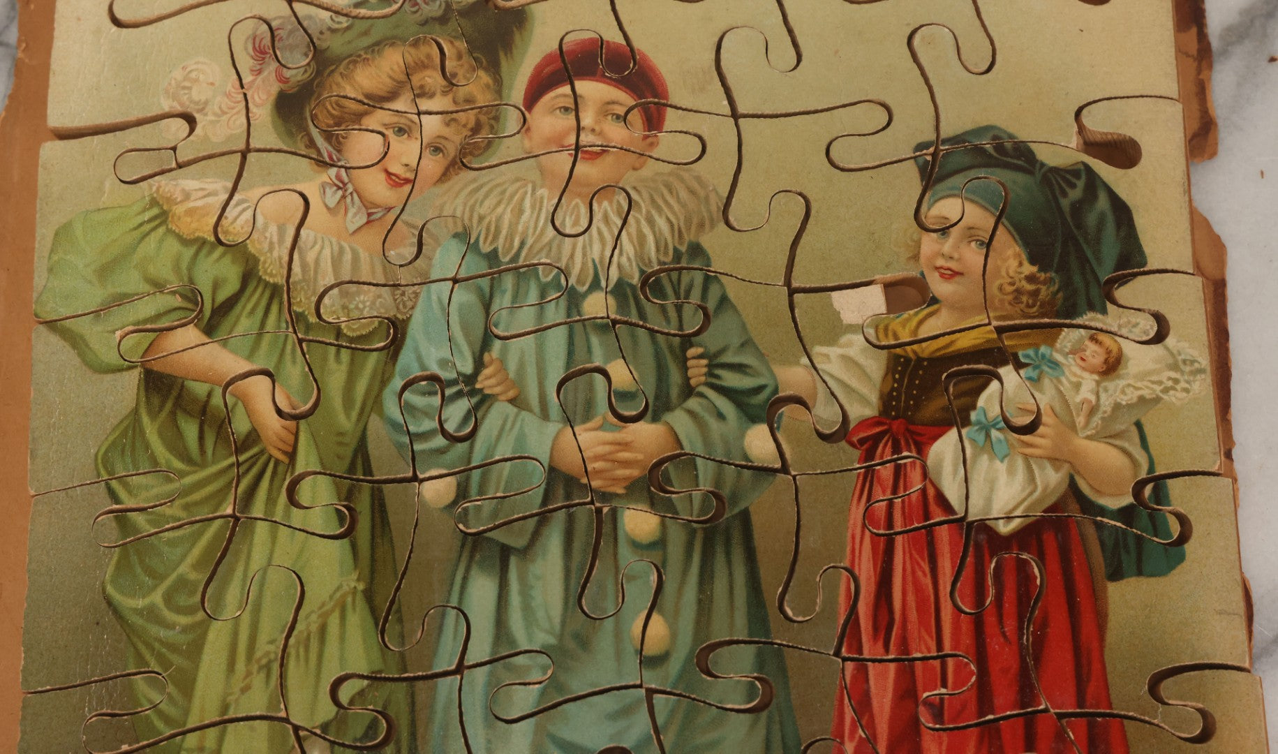 Lot 062 - Antique Double Sided Victorian Lithographed Wood Cut Jigsaw Puzzle With Scene Of Children In Costume With Clown And Children Blowing Bubbles, With Original Box And Partial Lithographed Lid