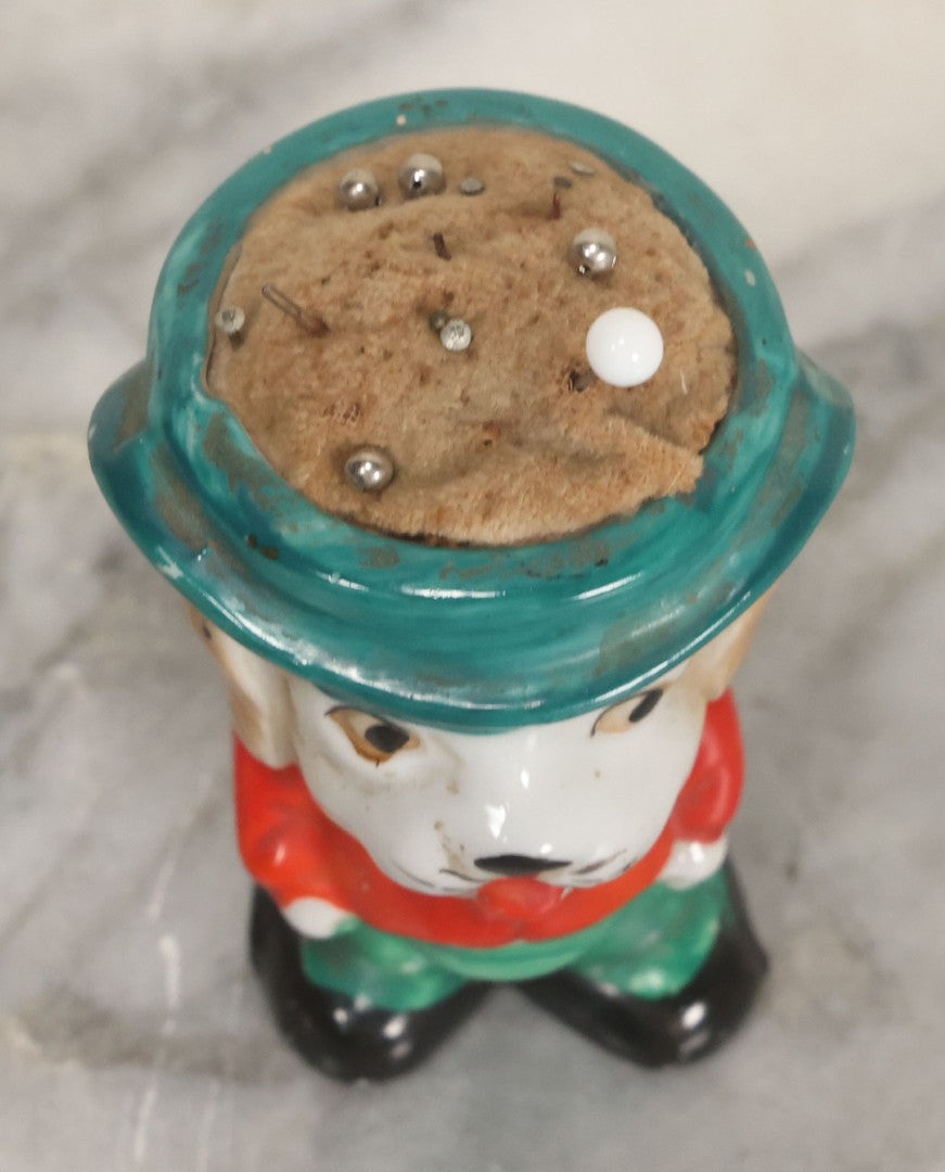 Lot 077 - Vintage Novelty Painted Porcelain Anthropomorphic Dog Caricature Pin Cushion, Made In Japan, With Several Ball Head Sewing Pins, 3-1/4" Height
