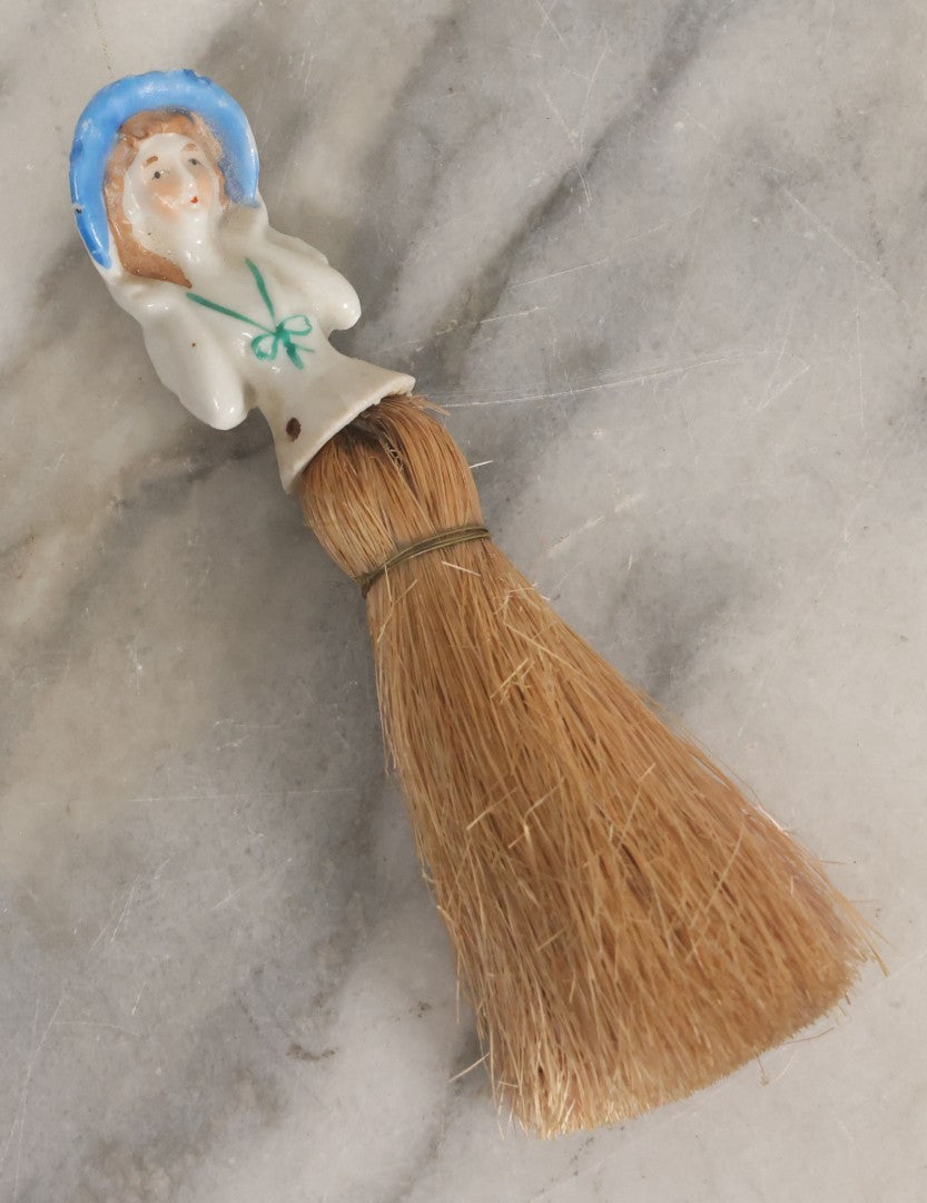 Lot 078 - Vintage Porcelain Lady With Blue Hat, Green Bow, Straw Dresser Brush, Made In Japan, Note Crack, Repair, 5-1/2" Length