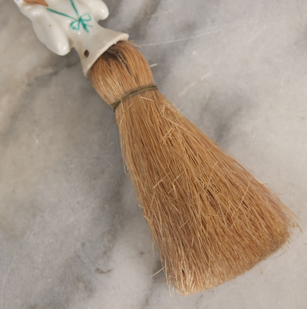 Lot 078 - Vintage Porcelain Lady With Blue Hat, Green Bow, Straw Dresser Brush, Made In Japan, Note Crack, Repair, 5-1/2" Length