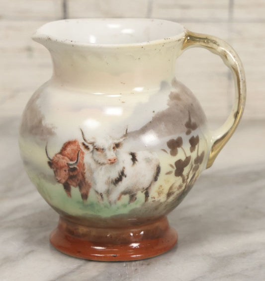 Lot 088 - Antique Royal Bayreuth Porcelain Creamer With White And Brown Cow Graphics, Painted Landscape Scene, 3-5/8" Height