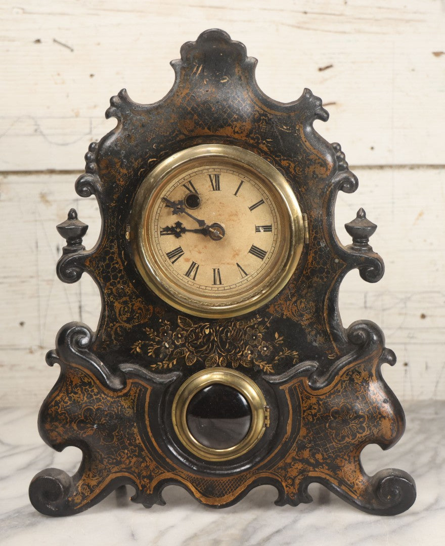 Lot 006 - Antique Metal And Wood Mantel Clock With Hand Painted Details, Paper Clock Face, And Domed Pendulum Window, With Paper Label Inside, Manufactured By The Waterbury Clock Co., Waterbury, Connecticut, Untested, No Pendulum, 13-1/8" H