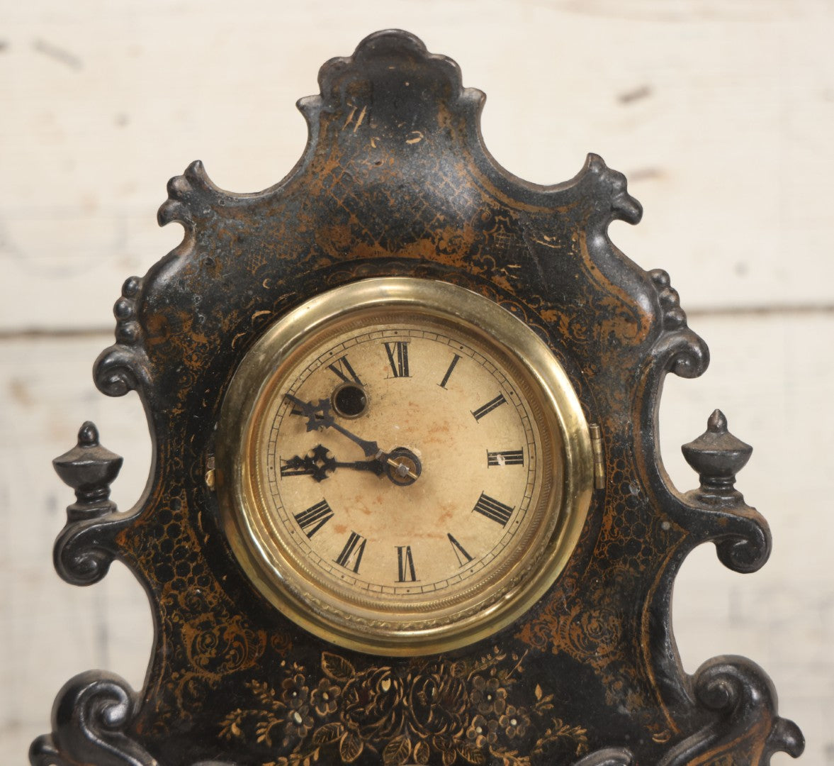 Lot 006 - Antique Metal And Wood Mantel Clock With Hand Painted Details, Paper Clock Face, And Domed Pendulum Window, With Paper Label Inside, Manufactured By The Waterbury Clock Co., Waterbury, Connecticut, Untested, No Pendulum, 13-1/8" H