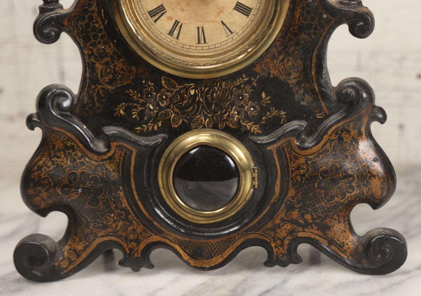 Lot 006 - Antique Metal And Wood Mantel Clock With Hand Painted Details, Paper Clock Face, And Domed Pendulum Window, With Paper Label Inside, Manufactured By The Waterbury Clock Co., Waterbury, Connecticut, Untested, No Pendulum, 13-1/8" H