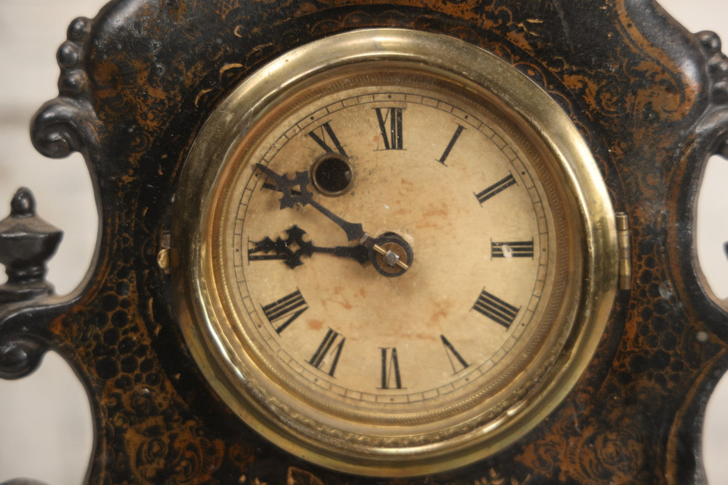 Lot 006 - Antique Metal And Wood Mantel Clock With Hand Painted Details, Paper Clock Face, And Domed Pendulum Window, With Paper Label Inside, Manufactured By The Waterbury Clock Co., Waterbury, Connecticut, Untested, No Pendulum, 13-1/8" H