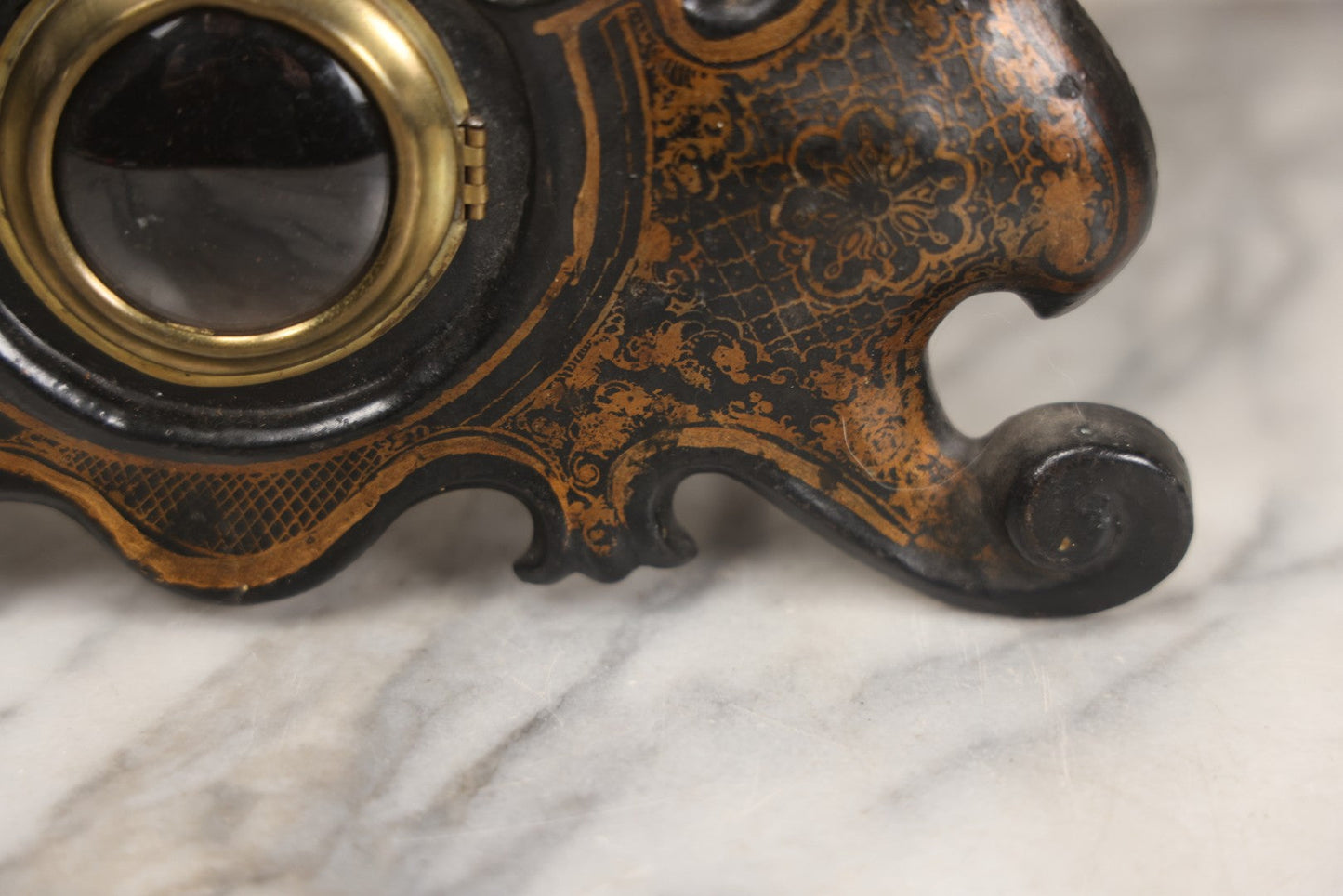 Lot 006 - Antique Metal And Wood Mantel Clock With Hand Painted Details, Paper Clock Face, And Domed Pendulum Window, With Paper Label Inside, Manufactured By The Waterbury Clock Co., Waterbury, Connecticut, Untested, No Pendulum, 13-1/8" H