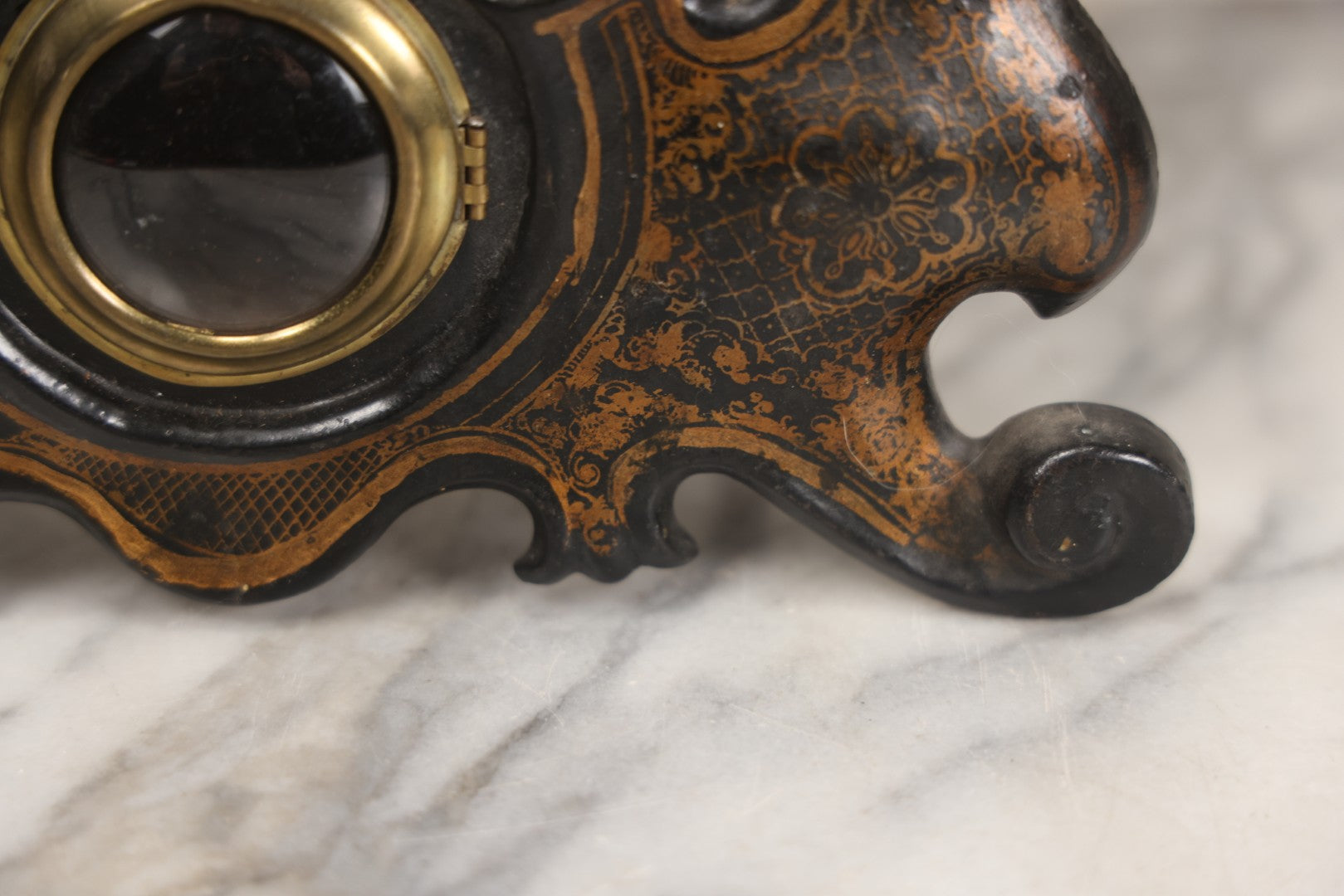 Lot 006 - Antique Metal And Wood Mantel Clock With Hand Painted Details, Paper Clock Face, And Domed Pendulum Window, With Paper Label Inside, Manufactured By The Waterbury Clock Co., Waterbury, Connecticut, Untested, No Pendulum, 13-1/8" H