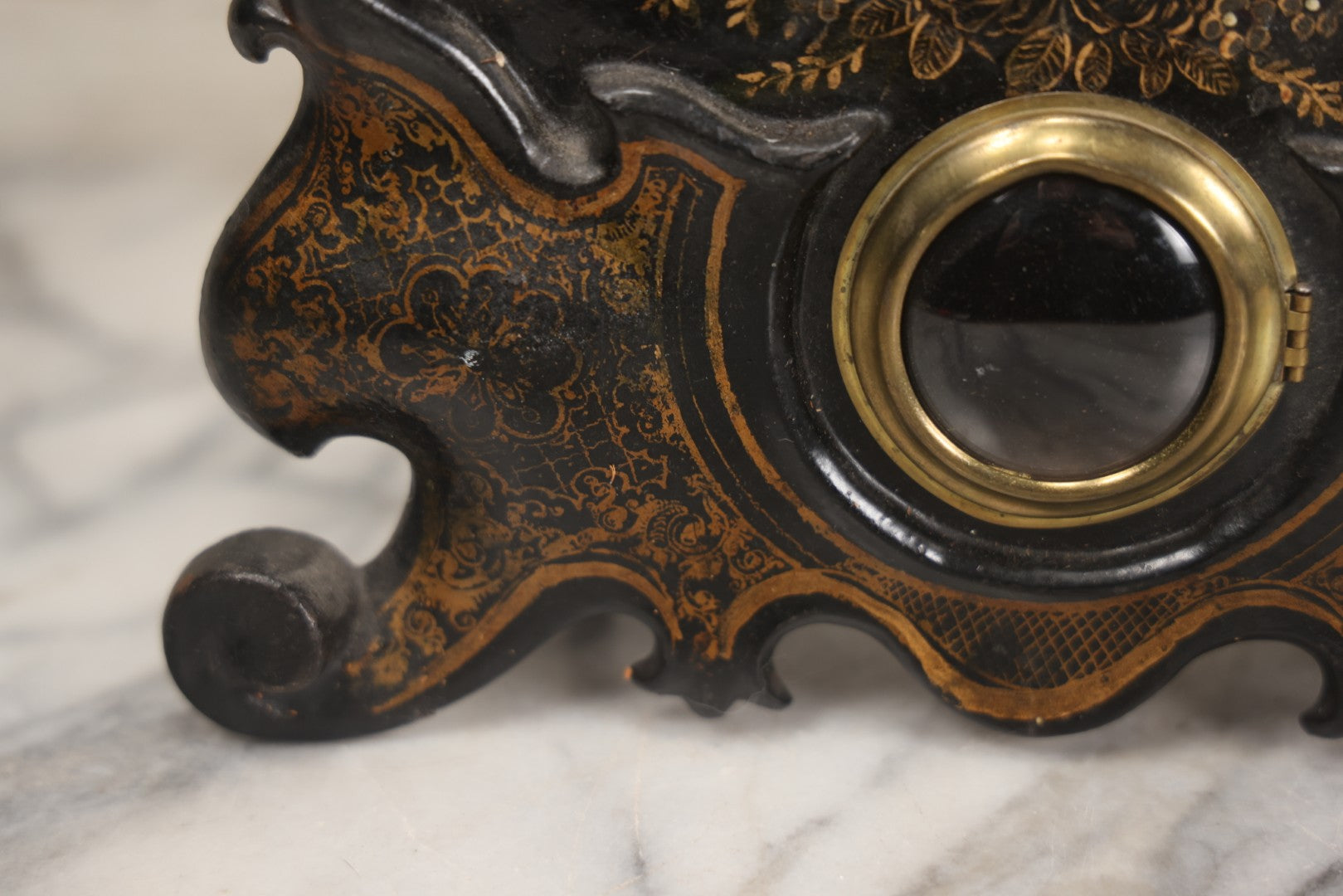 Lot 006 - Antique Metal And Wood Mantel Clock With Hand Painted Details, Paper Clock Face, And Domed Pendulum Window, With Paper Label Inside, Manufactured By The Waterbury Clock Co., Waterbury, Connecticut, Untested, No Pendulum, 13-1/8" H