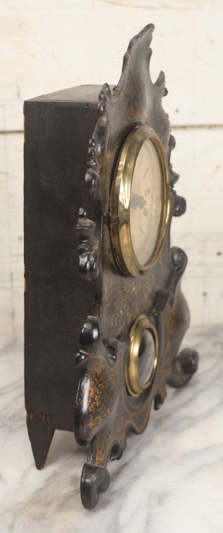 Lot 006 - Antique Metal And Wood Mantel Clock With Hand Painted Details, Paper Clock Face, And Domed Pendulum Window, With Paper Label Inside, Manufactured By The Waterbury Clock Co., Waterbury, Connecticut, Untested, No Pendulum, 13-1/8" H