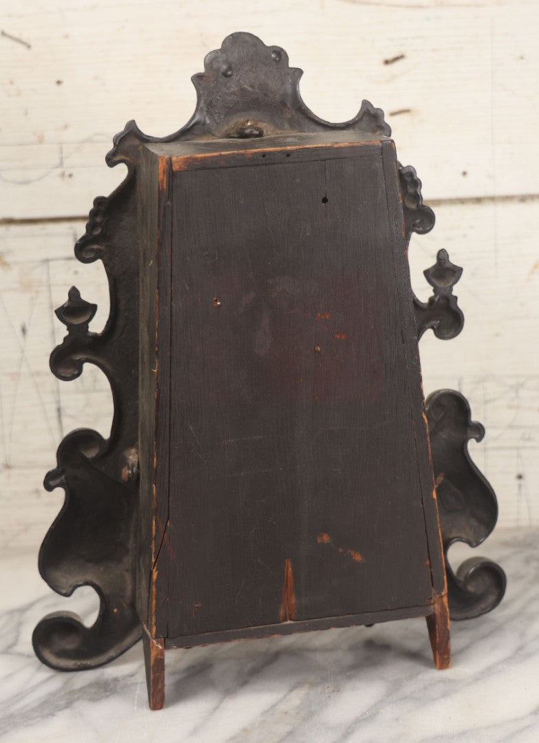 Lot 006 - Antique Metal And Wood Mantel Clock With Hand Painted Details, Paper Clock Face, And Domed Pendulum Window, With Paper Label Inside, Manufactured By The Waterbury Clock Co., Waterbury, Connecticut, Untested, No Pendulum, 13-1/8" H