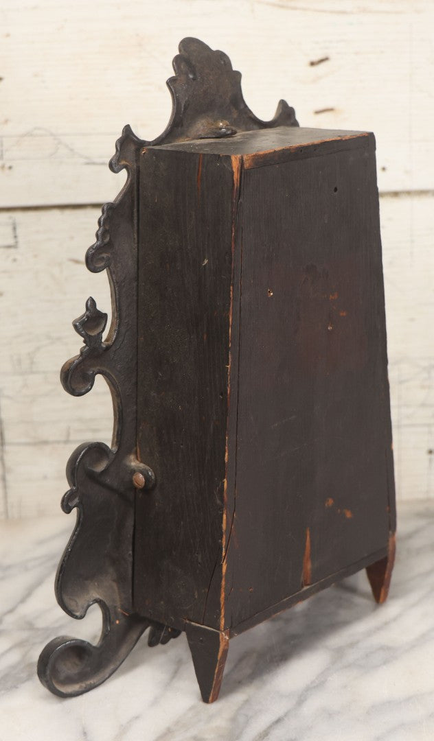 Lot 006 - Antique Metal And Wood Mantel Clock With Hand Painted Details, Paper Clock Face, And Domed Pendulum Window, With Paper Label Inside, Manufactured By The Waterbury Clock Co., Waterbury, Connecticut, Untested, No Pendulum, 13-1/8" H