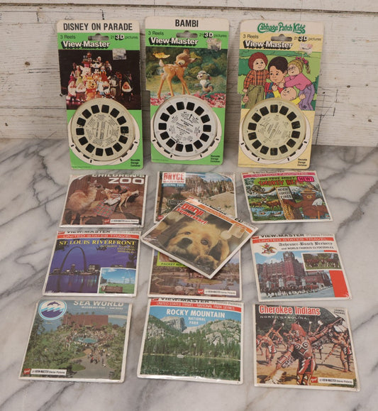 Lot 115 - Thirteen Piece Vintage Sealed Viewmaster Stereoview 3D Discs Including Cabbage Patch Kids, Bambi, Disney On Parade, Smokey Bear, And Many Travel Editions