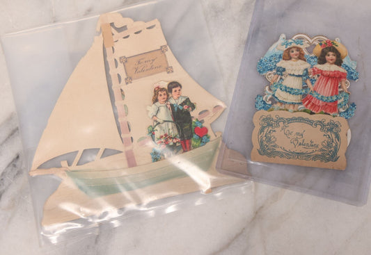 Lot 118 - Pair Of Antique Die Cut Valentines Including Two Girls In Colorful Dresses And Young Couple On Sailboat