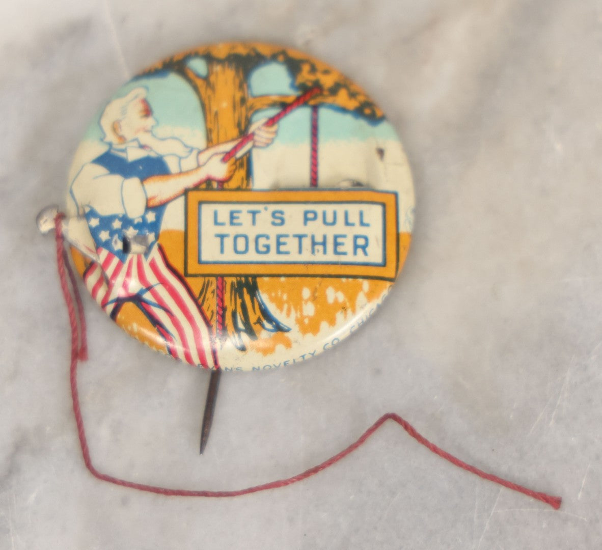 Lot 008 - Pair Of Vintage World War 2 Era Anti Hitler Pinback Buttons Including Animated Button Of Uncle Sam Hanging Hitler "Let's Pull Together," And "To Hell With Hitler" Blue Button