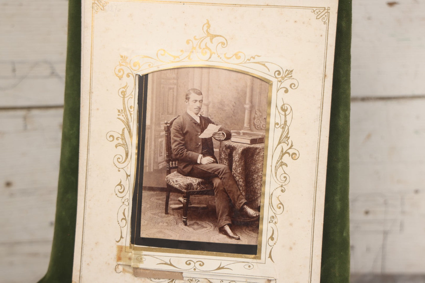 Lot 010 - Antique Victorian Green Velvet Display Photo Album With Stand And Tilt Down Cover, Brass Adornments, Containing 12 Cabinet Card And 24 C.D.V. Photographs And Images, Including Man Posing With Rifle, Sailor In Uniform, And Men Smoking