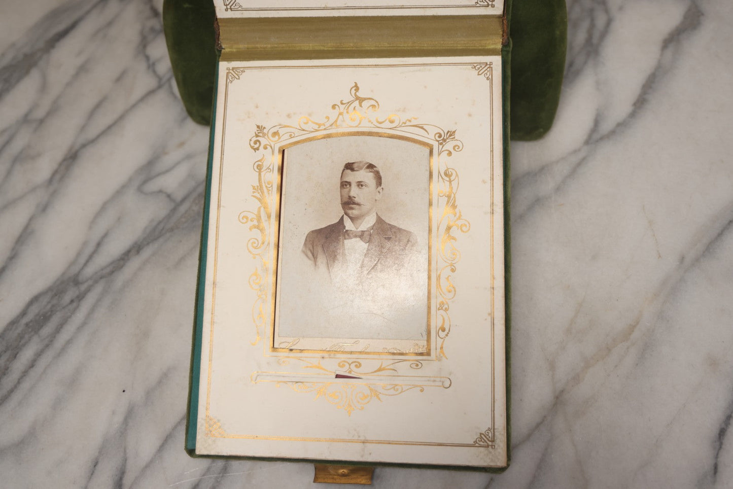 Lot 010 - Antique Victorian Green Velvet Display Photo Album With Stand And Tilt Down Cover, Brass Adornments, Containing 12 Cabinet Card And 24 C.D.V. Photographs And Images, Including Man Posing With Rifle, Sailor In Uniform, And Men Smoking