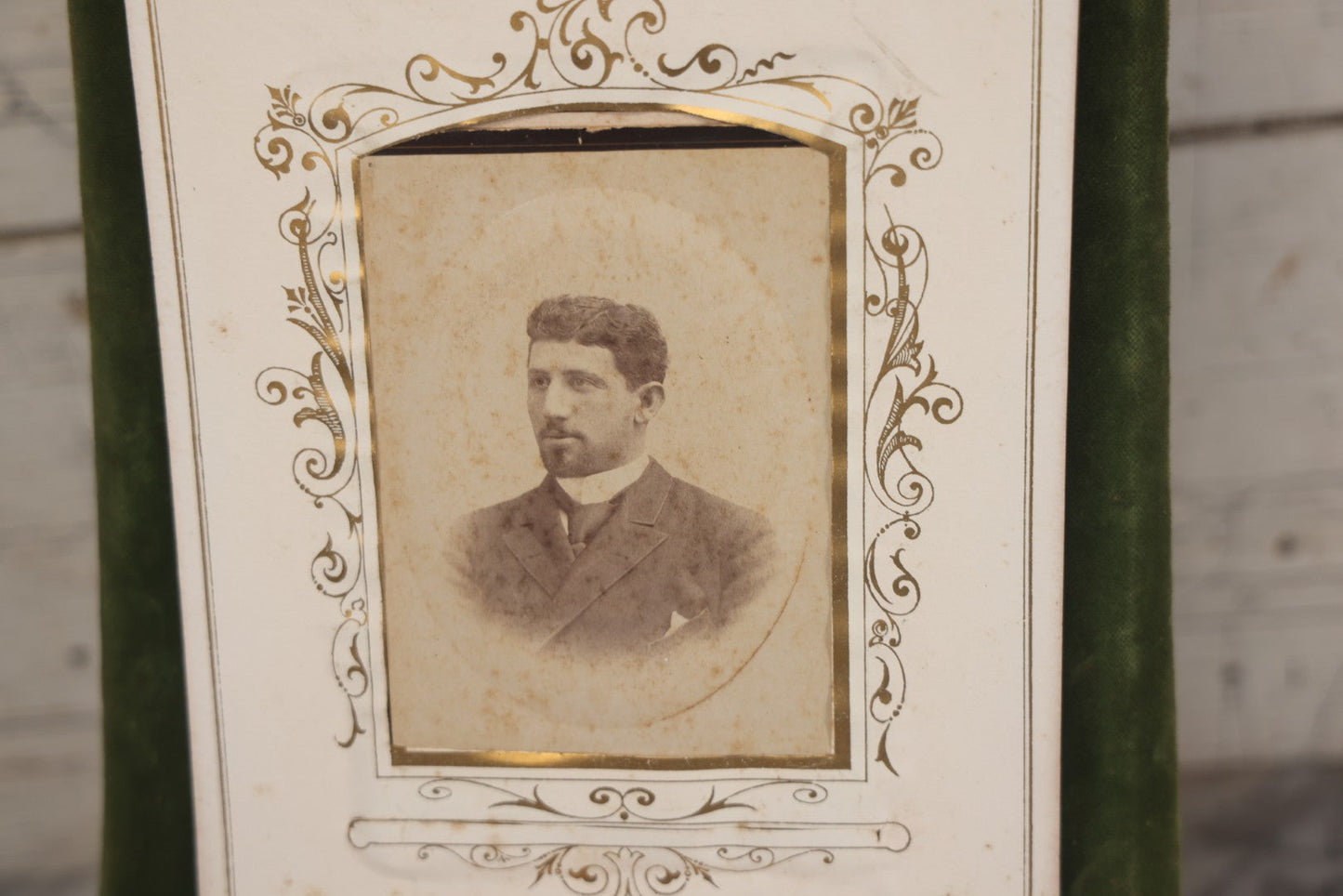 Lot 010 - Antique Victorian Green Velvet Display Photo Album With Stand And Tilt Down Cover, Brass Adornments, Containing 12 Cabinet Card And 24 C.D.V. Photographs And Images, Including Man Posing With Rifle, Sailor In Uniform, And Men Smoking