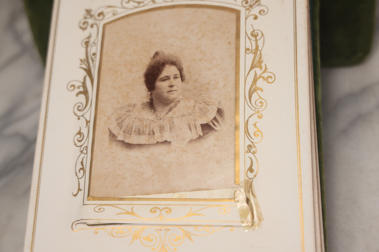 Lot 010 - Antique Victorian Green Velvet Display Photo Album With Stand And Tilt Down Cover, Brass Adornments, Containing 12 Cabinet Card And 24 C.D.V. Photographs And Images, Including Man Posing With Rifle, Sailor In Uniform, And Men Smoking