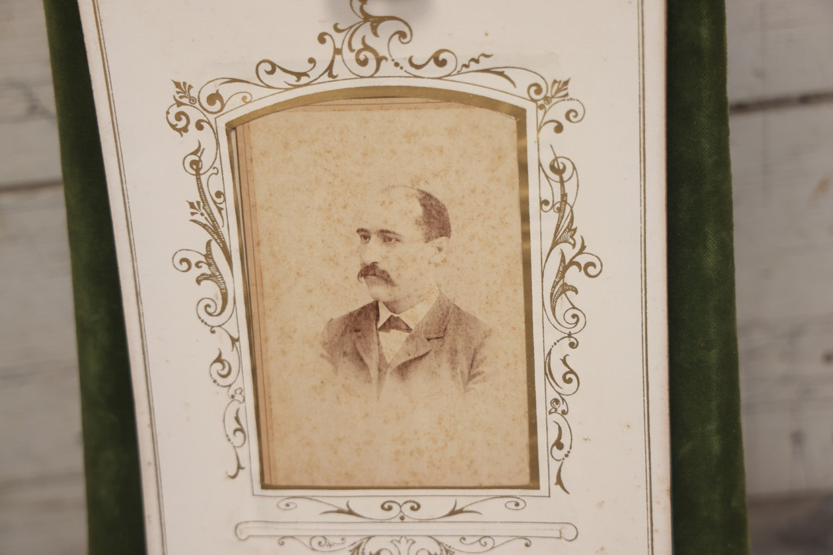 Lot 010 - Antique Victorian Green Velvet Display Photo Album With Stand And Tilt Down Cover, Brass Adornments, Containing 12 Cabinet Card And 24 C.D.V. Photographs And Images, Including Man Posing With Rifle, Sailor In Uniform, And Men Smoking