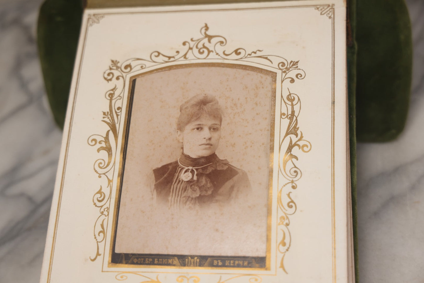 Lot 010 - Antique Victorian Green Velvet Display Photo Album With Stand And Tilt Down Cover, Brass Adornments, Containing 12 Cabinet Card And 24 C.D.V. Photographs And Images, Including Man Posing With Rifle, Sailor In Uniform, And Men Smoking