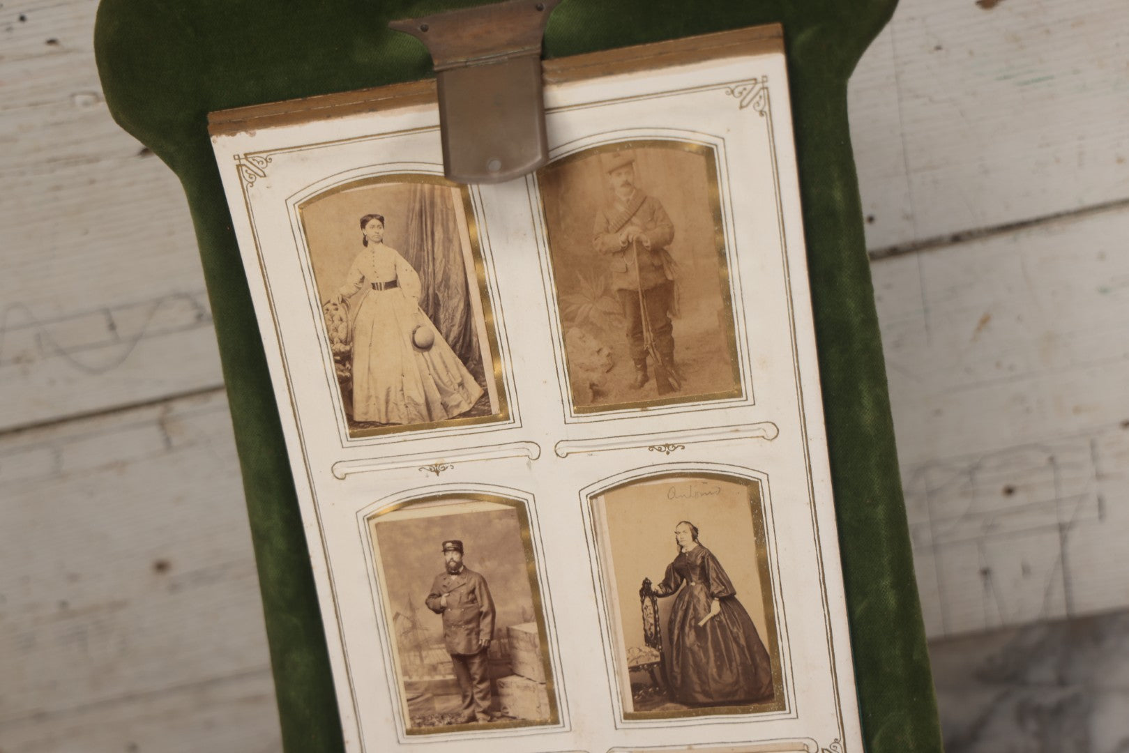 Lot 010 - Antique Victorian Green Velvet Display Photo Album With Stand And Tilt Down Cover, Brass Adornments, Containing 12 Cabinet Card And 24 C.D.V. Photographs And Images, Including Man Posing With Rifle, Sailor In Uniform, And Men Smoking