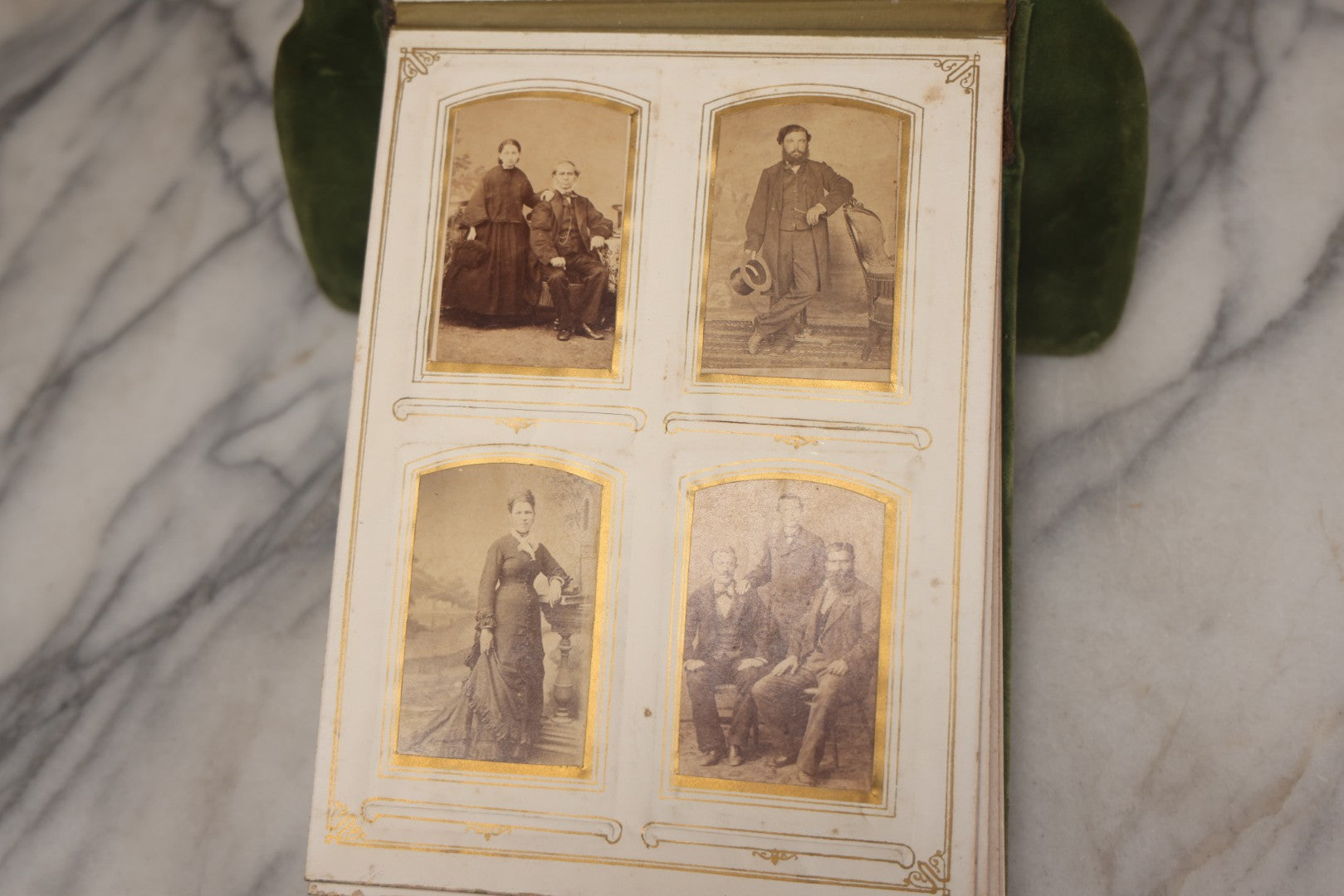 Lot 010 - Antique Victorian Green Velvet Display Photo Album With Stand And Tilt Down Cover, Brass Adornments, Containing 12 Cabinet Card And 24 C.D.V. Photographs And Images, Including Man Posing With Rifle, Sailor In Uniform, And Men Smoking