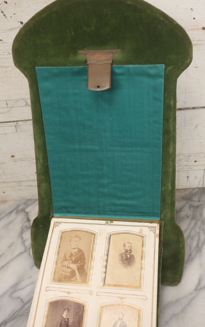 Lot 010 - Antique Victorian Green Velvet Display Photo Album With Stand And Tilt Down Cover, Brass Adornments, Containing 12 Cabinet Card And 24 C.D.V. Photographs And Images, Including Man Posing With Rifle, Sailor In Uniform, And Men Smoking