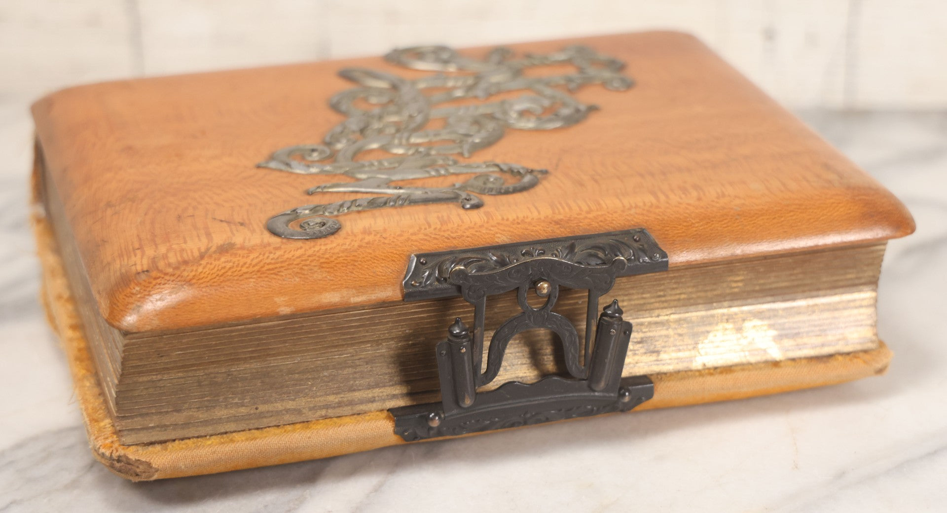Lot 012 - Antique Victorian Photo Album With Wood Cover And Silverplate Emblem, Containing Twenty Antique Photographs Of Various Types, Including Man In Office, Children With Pram, Man With White Beard, Note Binding Wear Cover Loosening