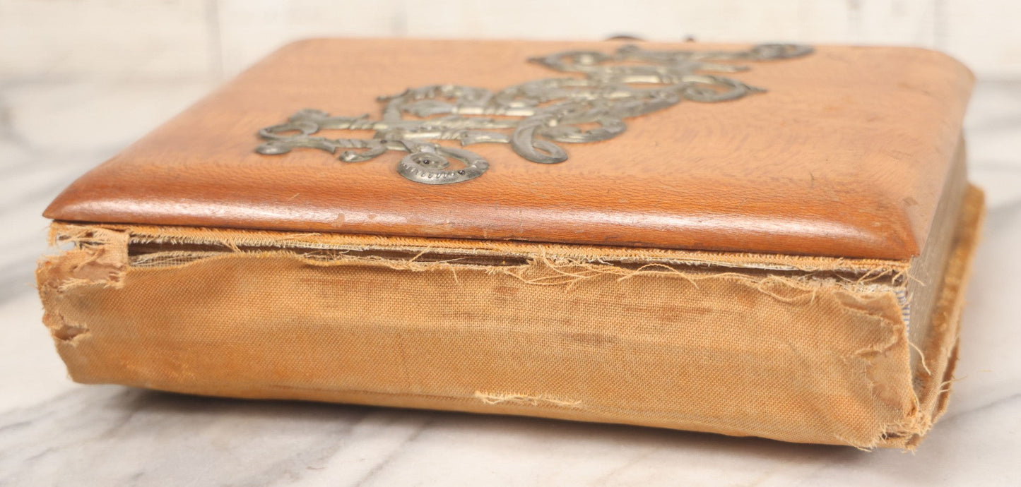 Lot 012 - Antique Victorian Photo Album With Wood Cover And Silverplate Emblem, Containing Twenty Antique Photographs Of Various Types, Including Man In Office, Children With Pram, Man With White Beard, Note Binding Wear Cover Loosening