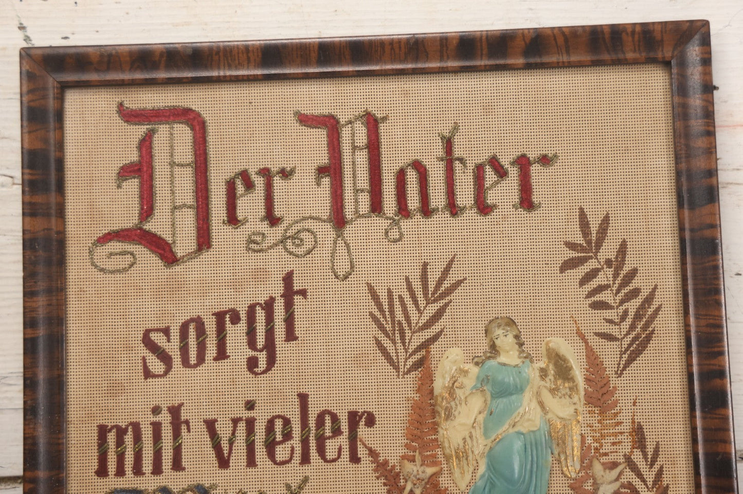 Lot 021 - Antique German Paper Punch Needlework Embroidery Motto, Translates To "The Father Cares With Much Effort For His Children, Late And Early" With Celluloid Angel Figure And Pressed Ferns, In Frame, 12-7/8" x 16-7/8"