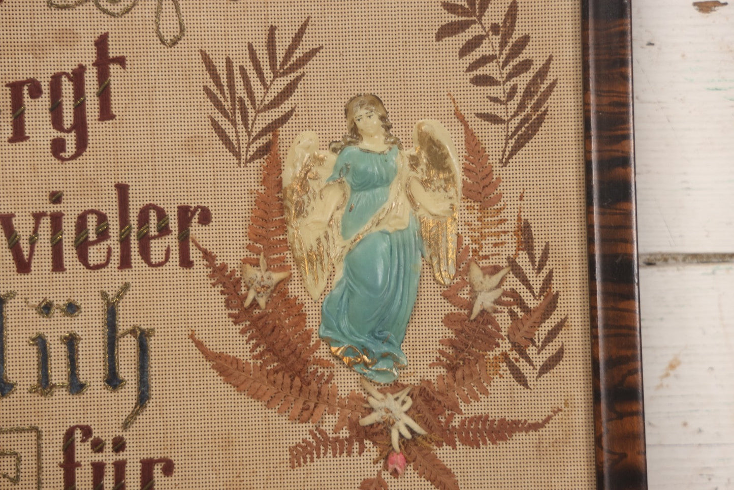 Lot 021 - Antique German Paper Punch Needlework Embroidery Motto, Translates To "The Father Cares With Much Effort For His Children, Late And Early" With Celluloid Angel Figure And Pressed Ferns, In Frame, 12-7/8" x 16-7/8"