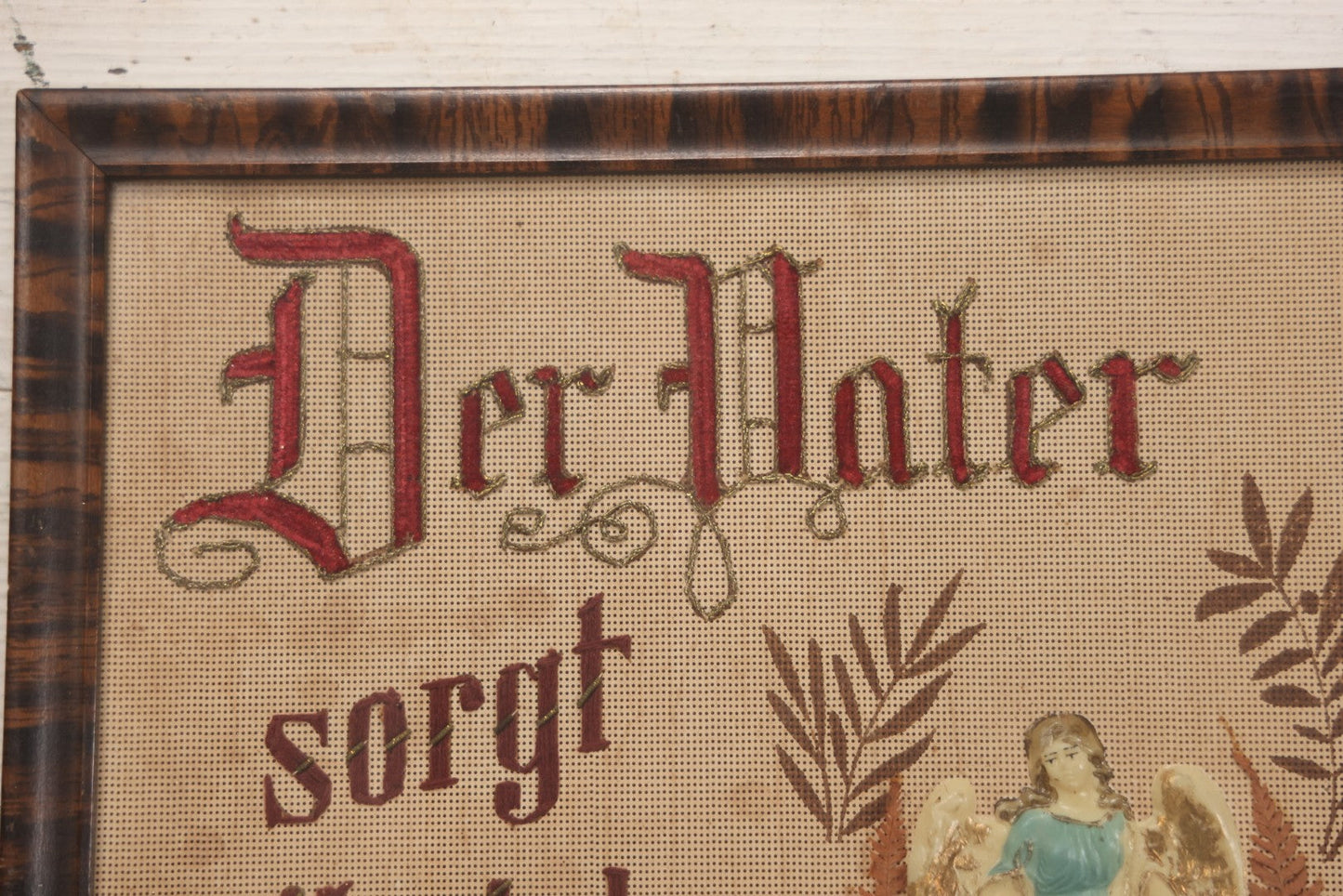 Lot 021 - Antique German Paper Punch Needlework Embroidery Motto, Translates To "The Father Cares With Much Effort For His Children, Late And Early" With Celluloid Angel Figure And Pressed Ferns, In Frame, 12-7/8" x 16-7/8"