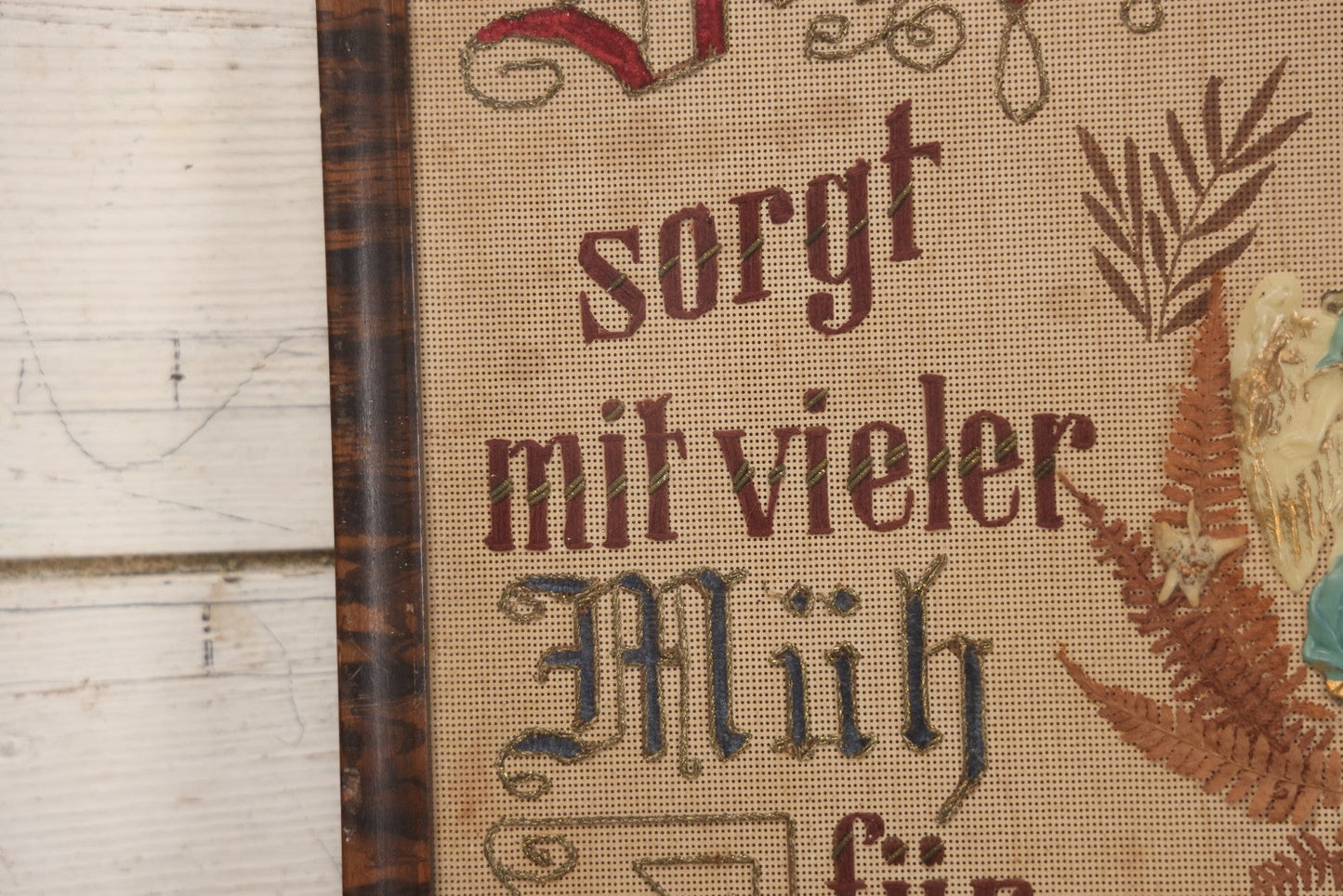 Lot 021 - Antique German Paper Punch Needlework Embroidery Motto, Translates To "The Father Cares With Much Effort For His Children, Late And Early" With Celluloid Angel Figure And Pressed Ferns, In Frame, 12-7/8" x 16-7/8"