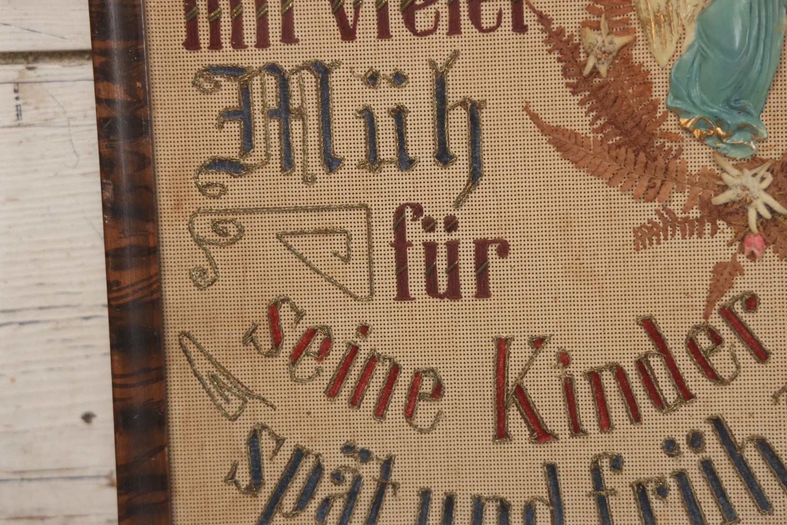 Lot 021 - Antique German Paper Punch Needlework Embroidery Motto, Translates To "The Father Cares With Much Effort For His Children, Late And Early" With Celluloid Angel Figure And Pressed Ferns, In Frame, 12-7/8" x 16-7/8"